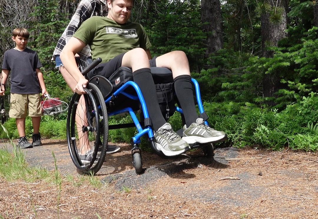 A wheelchair user navigating an uneven path at Jubilee Lake