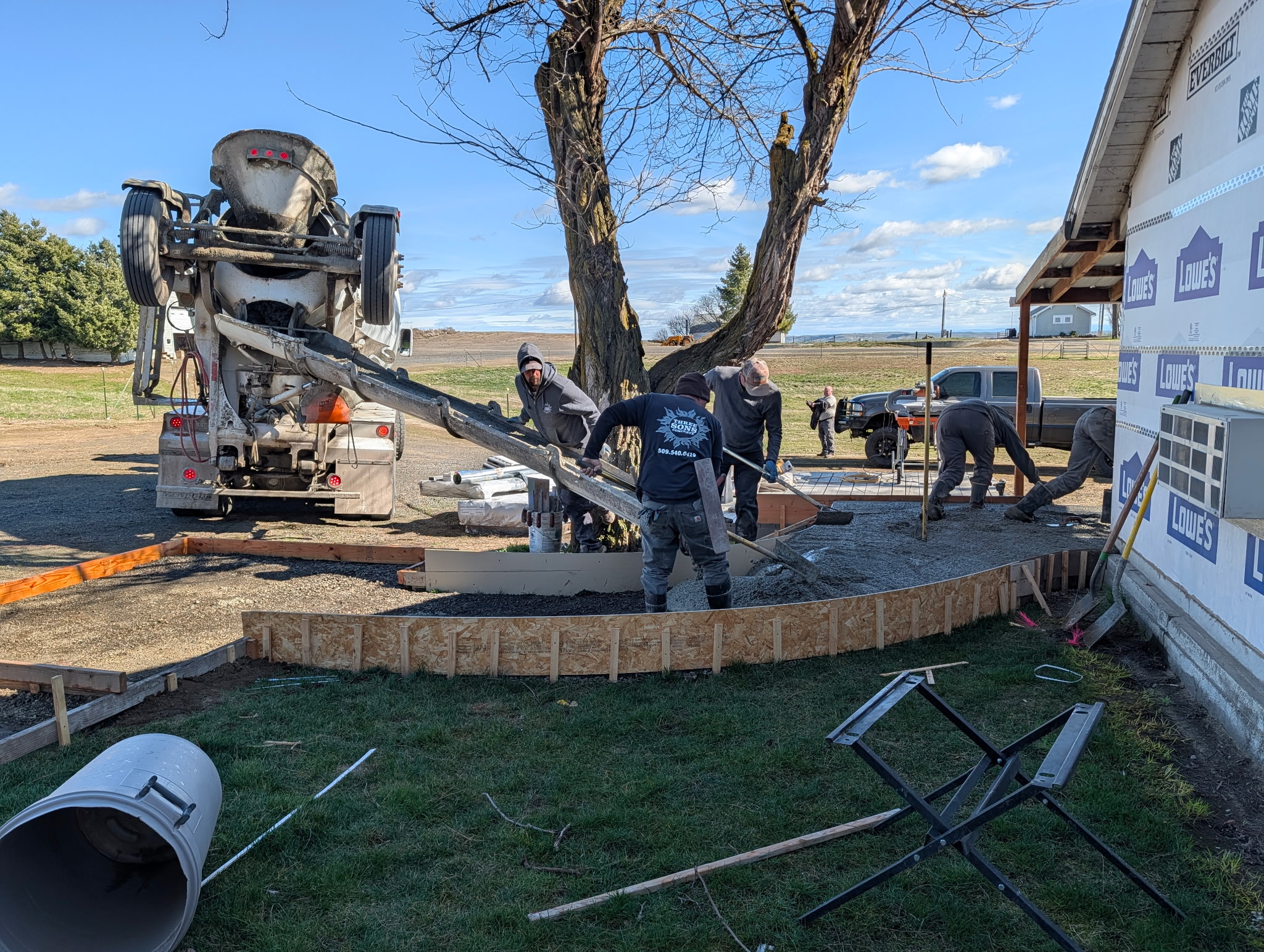 A crew pouring concrete for accessibility improvements at Tyler Hoffman’s home